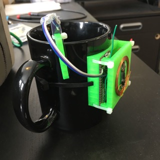 All the parts mounted in a 3D printed case, hanging on the coffee mug.